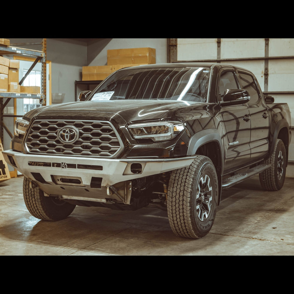 Quartering front view of the C4 Overland front winch bumper in raw steel like it ships to all customers.