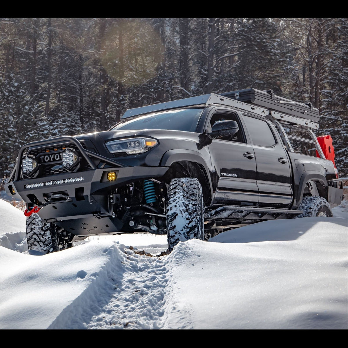 Tacoma in the snow and equipped for adventure.