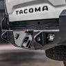 Quartering side view of the hidden hitch receiver concealed under the license plate mount on the C4 Overland rear bumper.