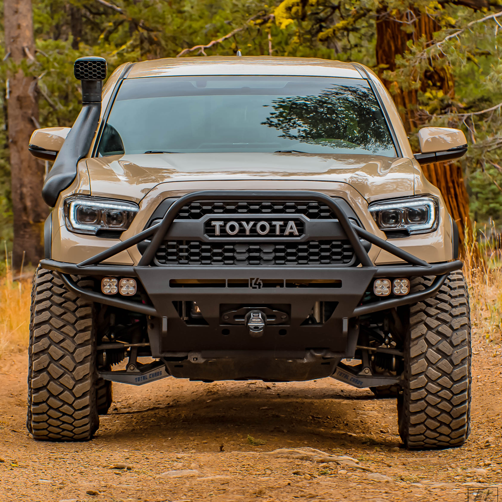 Tan Toyota Tacoma equipped with the C4 Hybrid winch bumper with full-height bull bar with tube gussets. 