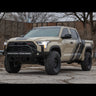 Tan Toyota Tundra TRD Pro in an abandoned parking lot equipped with the Overland bumper from C4.