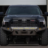 Straight-on view of a black 3rd Gen Tundra with a C4 Overland front bumper in raw steel. 