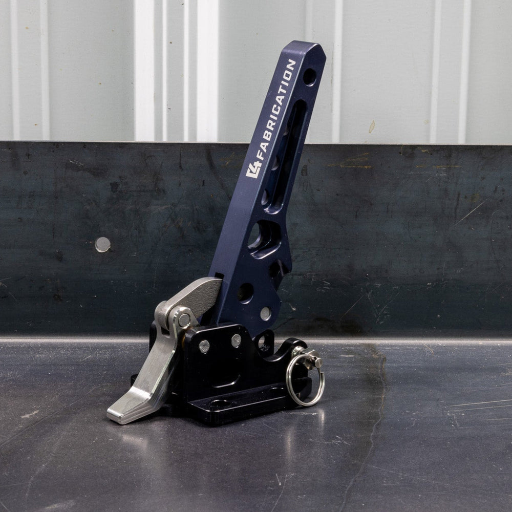 Quartering view of the C4 Fabrication rear swing latch sitting on a metal table.