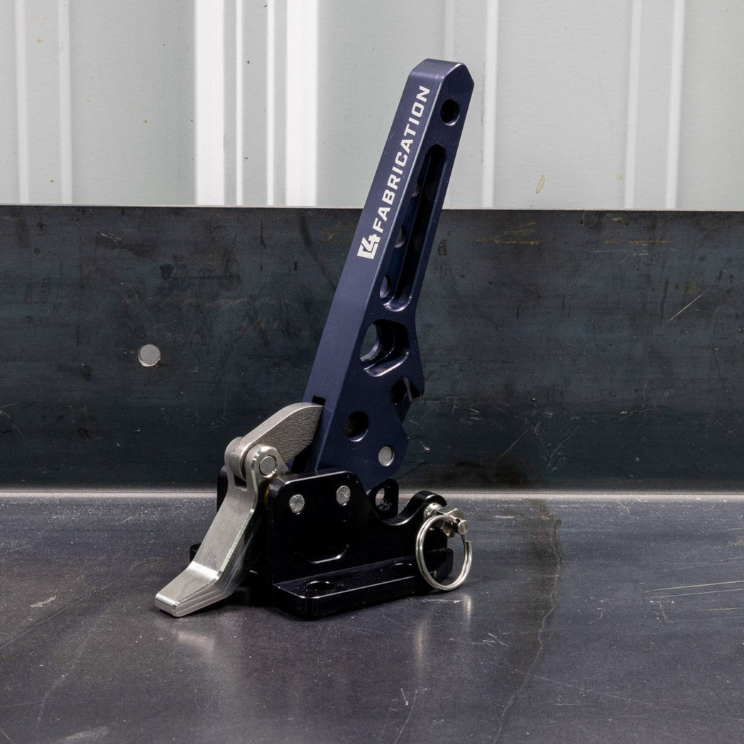 Quartering view of the C4 Fabrication rear swing latch sitting on a metal table.