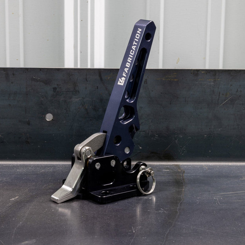 Quartering view of the C4 Fabrication rear swing latch sitting on a metal table.