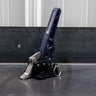 Quartering view of the C4 Fabrication rear swing latch sitting on a metal table.