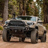 Tan Tacoma on a mountain trail with a C4 Hybrid bumper with full-height bull bar with tube gussets.