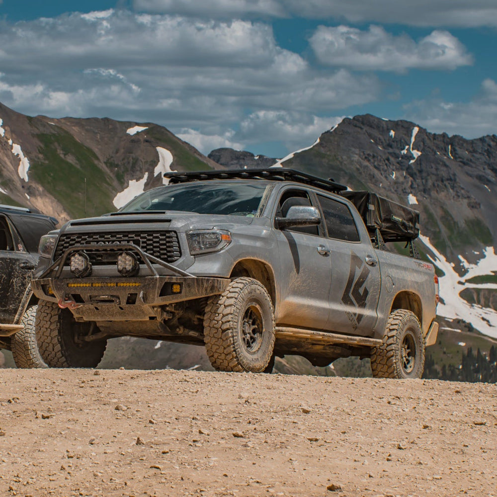 Grey Tundra CrewMax exploring the mountains with C4 Overland bumper installed.