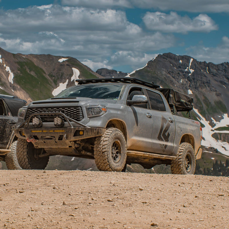 Grey Tundra CrewMax exploring the mountains with C4 Overland bumper installed.