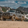 Grey Tundra CrewMax exploring the mountains with C4 Overland bumper installed.