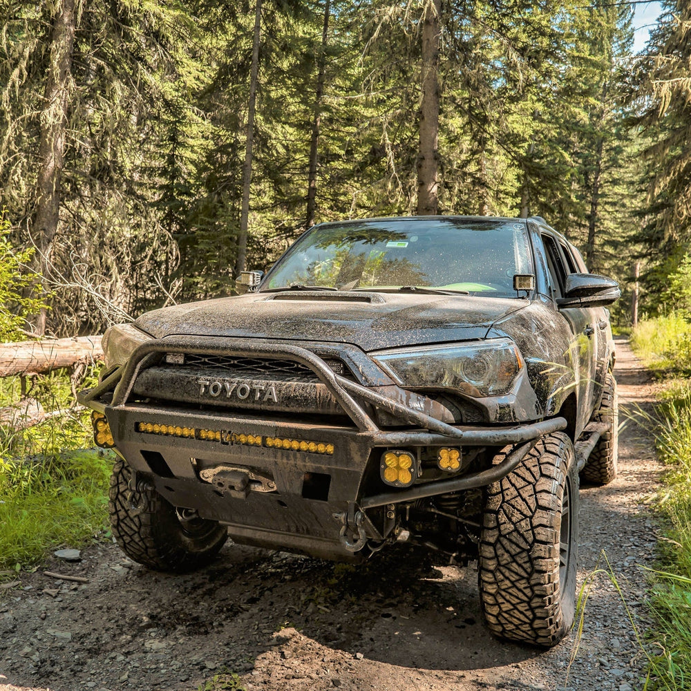 Quartering on photo of a muddy 5th Gen 4Runner equipped with a C4 Hybrid bumper.