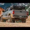 Closer view of the C4 Overland rear bumper on a Tundra exploring a mountain trail.